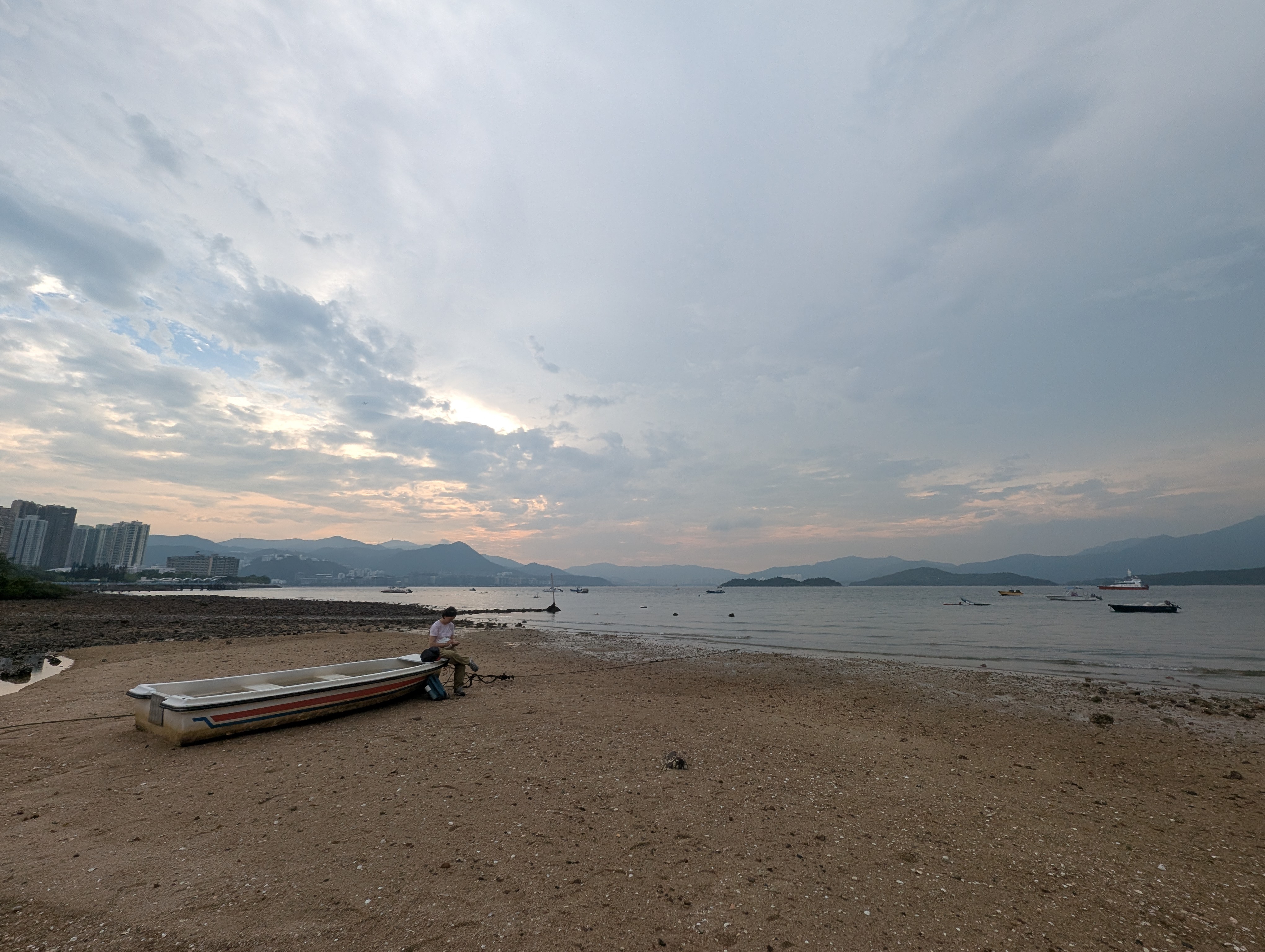 Felt like this was a good photo, the boat with the local on their phone, the greyish sky, the city always visible in the background, but the mountains still poking through (real Hong Kong vibes for me)